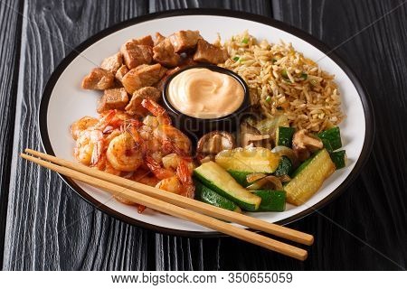 Serving Hibachi Of Rice, Shrimp, Steak And Vegetables Served With Sauce Closeup In A Plate. Horizont