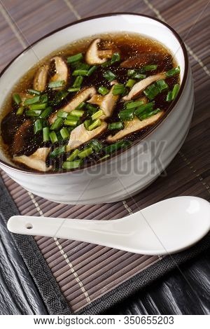 Japanese Miso Soup With Shiitake Mushrooms And Green Onions Close-up In A Bowl. Vertical