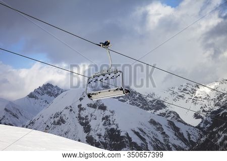 Sunlit Chair Lift, Snowy Ski Slope, High Winter Mountains And Blue Cloudy Sky. Ski Area Mottolino Fu