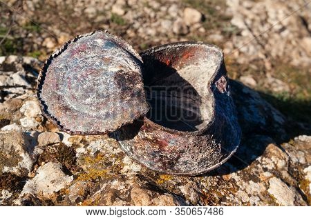 Old Rusty Tin Can Covered With Ash On Stone At Sunny Day. Concept Of Environmental Pollution, Ecolog