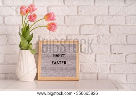 Easter Hliday Concept. Vase With Tulips And Gray Felt Letter Board With Words Happy Easter On White 