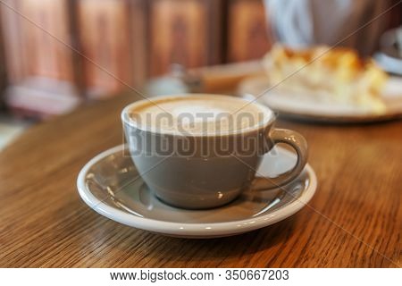 Coffee Cup Fresh Cream Organic Cappuccino On Table In Cafe. Latte Macchiato Drink In Glass Close Up.