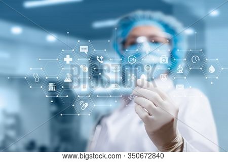 Doctor Shows A Pill On The Background Of The Structure Of Medical Icons.