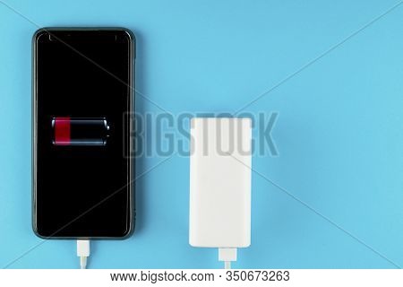 The Phone Is Charged By Powerbank. Powerful Powerbank Charges Your Smartphone.