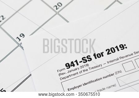 Irs Form 941-ss Employers Quarterly Federal Tax Return Blank Lies On Empty Calendar Page