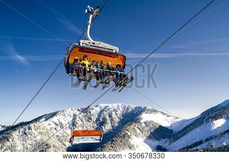Demanovska Dolina, Slovakia - February 8: Skiers Sitting On Ski Lift Chair  In Ski Resort Jasna On F