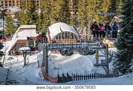 Demanovska Dolina, Slovakia - February 8: Skiers Sitting On Ski Lift Chair In Resort Jasna In Low Ta