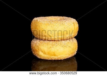 Group Of Two Whole Sweet Golden Mini Cinnamon Donut Isolated On Black Glass