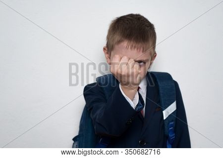 Schoolboy Threatens With His Fist. Boy In School Uniform. White Background. Brawler