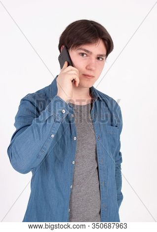 Young Smiling Man Talking On The Mobile Phone And Looking Away. Isolated On White.