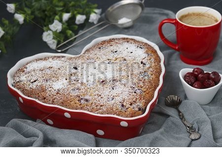 Oatmeal Pie With Cherry Dusted With Powdered Sugar In A Ceramic Form In The Shape Of A Heart On A Da