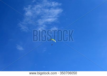 A paraglider in the sky. Ultra-light aircraft, created on the basis of bicornic parachutes.