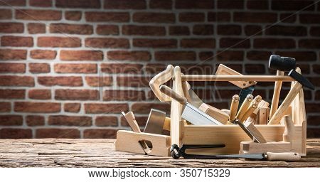 Toolbox With Carpenter Worktools Against Brick Background