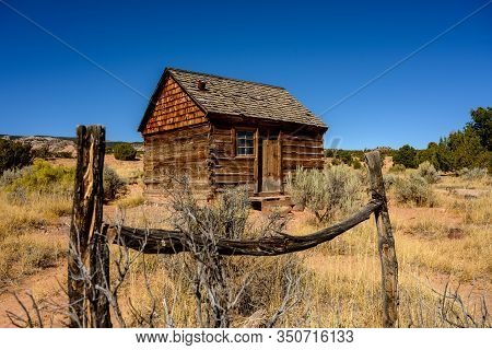Morrell Line Cabin Framed In Old Fence In Utah Desert