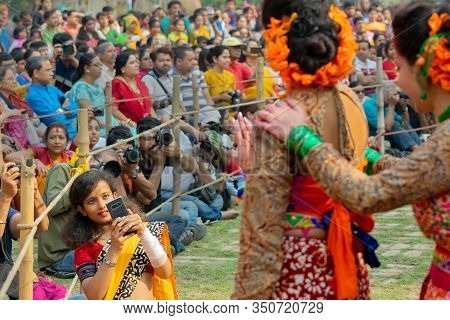 Kolkata, India- 1st March 2018: Girl Taking Picture Of Dancers Dressed In Colourful Sari (traditiona