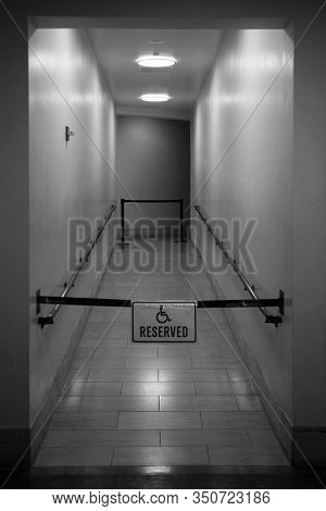 Hallway. Handy Cap Access Hallway. Closed off hallway with Handy Cap access sign. Interior walkway of a building in Los Angeles California. Black & White. 