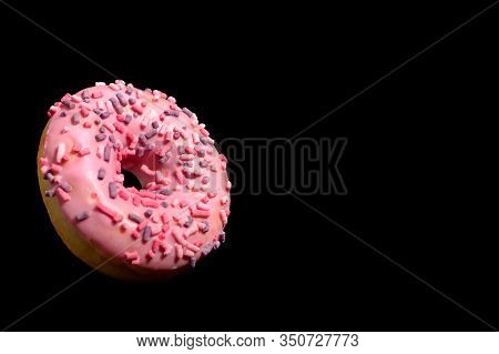 Donut With Pink Icing And Marshmellow. Flying Dougnut On Black Background.