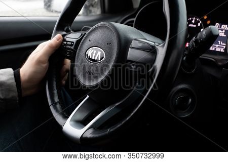 Moscow, Russia - January 2, 2020: Male Hand On The Steering Wheel Of A Kia Rio X-line Car. Black Ste