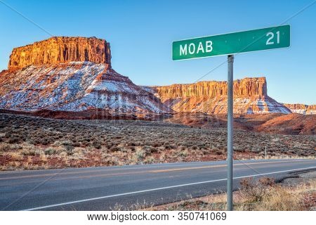 Moab 21 miles road sign near Casttle Valley in Utah, winter sunrise scenery - travel and recreation concept