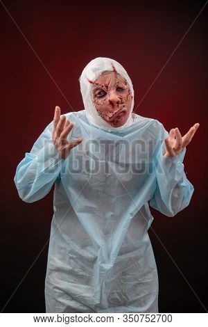 Crazy Zombie Horror Make Up. Person In Blue Madical Shirt And Bandaged Head. Scars, Deep Scratches R
