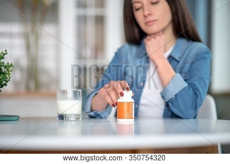 Woman Holding A Container With Life Extansion Pills