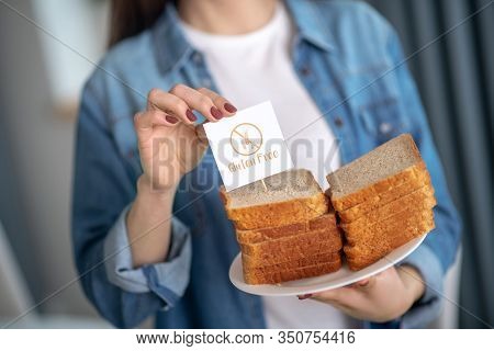 Woman Holding A Plate With Glutein Free Bread