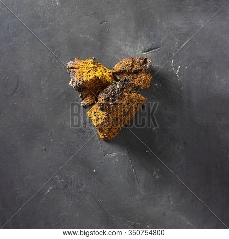 Wild Chaga Mushroom Lives On Birch Bark, Inonotus Obliquus, Heart Shape On Dark Textured Background.