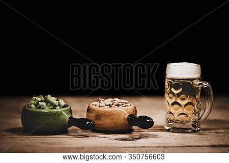 Hop Pellets And Malted Barley With A Beer Glass On Wooden Ground, Ingredients For Brewing Beer In A 