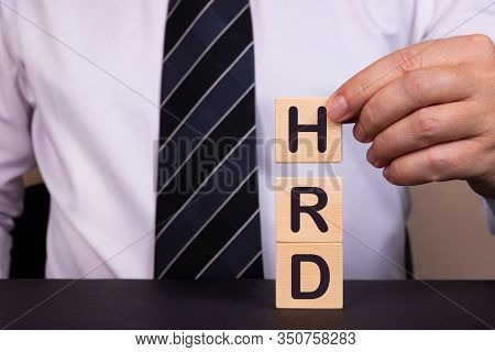 Businessman Made Word Hrd With Wood Building Blocks.