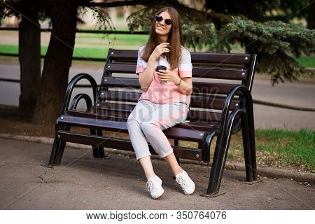 Git In Sunglasses Sit On Bench And Drink Coffee