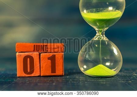 June 1st. Day 1 Of Month, Handmade Wood Cube With Date Month And Day And Hourglass With Green Sand. 
