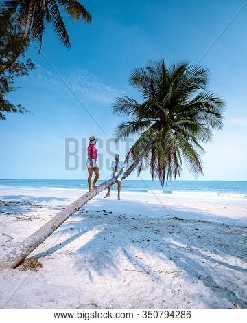 Wua Laen Beach Chumphon Area Thailand, Palm Tree Hanging Over The Beach With Couple On Vacation In T