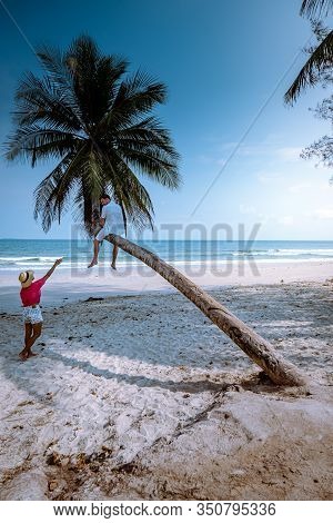 Wua Laen Beach Chumphon Area Thailand, Palm Tree Hanging Over The Beach With Couple On Vacation In T