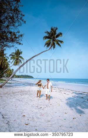 Wua Laen Beach Chumphon Area Thailand, Palm Tree Hanging Over The Beach With Couple On Vacation In T
