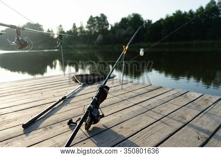 Carp Fishing On Beautiful Blue Lake With Carp Rods And Rod Pods In The Summer Morning. Fishing From 