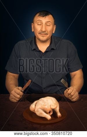 Studio Portrait Of The Hungry Person On A Blue Background. Wants Will Regale On Poultry. Gluttony An