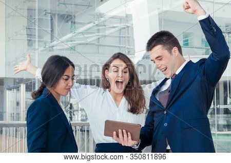 Three Good Looking Colleagues Standing In Office Corridor, Man And Woman In White Blouse Exulting, R