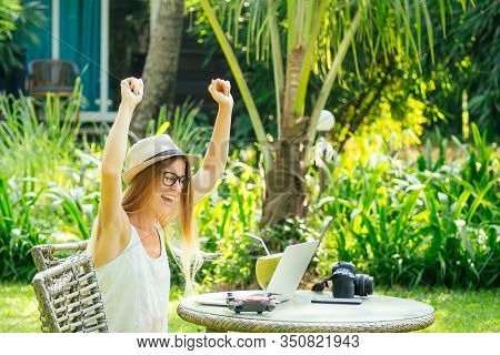 Young Photographer Woman Feeling Happy Becouse She Get Money Online While Sitting At Tropical Cafe