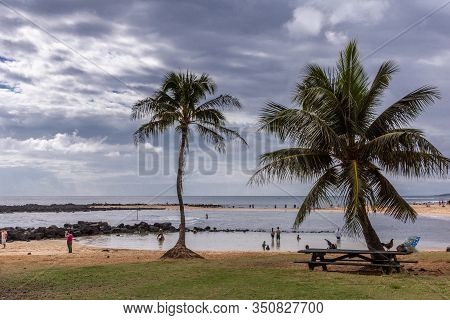 Poipu Beach, Kauai, Hawaii, Usa. - January 11, 2012: From Green Grassy Area Bordering Brown Sand Loo