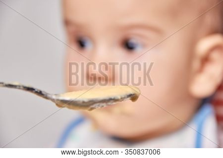 Spoon With Porridge For A Child, The Concept Of Feeding A Child Through The Eyes Of An Adult