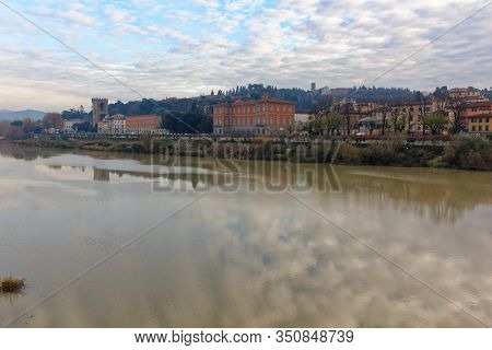 View Of Arno River In Florence Firenze Italy From One Of The Shores During Sunset In Winter
