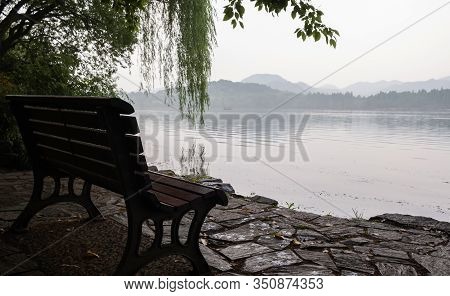 View Of Green Environment With Tree, Seat Bench And Park At Xihu Lake Or The West Lake In The Mornin