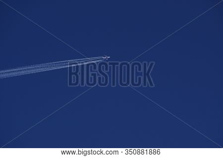 Clear Blue Sky With Random Traces Of Burned Fuel From The Plane On A Clear Sunny Day.