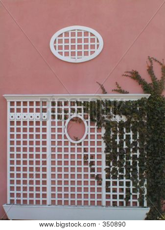 Roze pleisterwerk en witte Lattice