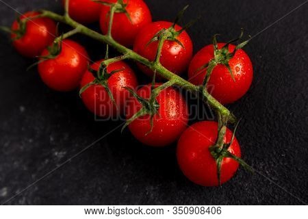 Red Cherry Tomatoes On A Black Background