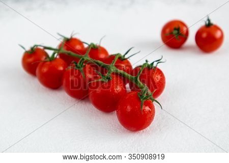 Red Cherry Tomatoes On A White Background