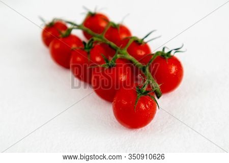 Red Cherry Tomatoes On A White Background