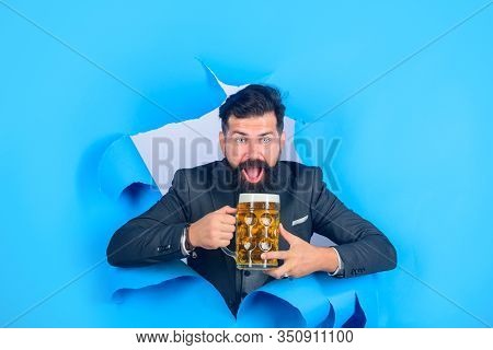 Oktoberfest. Satisfed Man With Beard Holds Mug Of Beer. Stylish Man Drinks Beer. Lager And Dark Beer
