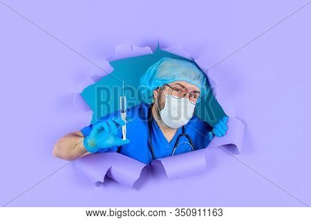 Through Paper. Doctor With Syringe. Medicine. Closeup Injection. Concept Of Vaccination. Doctor With