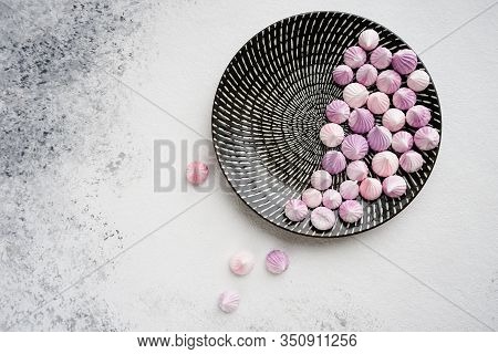 Sweet Dessert On A Black Round Plate With Ornament